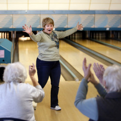 Julie Davidson of Portland celebrates with her teammates after bowling a strike Tuesday at West-Port Bowling Lanes in Westbrook. A new candlepin bowling alley is opening this spring in Westbrook, the third candlepin facility in town. Tod Lyter, who’s opening the new alley at Pride’s Corner, says the popular sport provides enough customers for all three businesses. (Derek Davis/Staff Photographer)