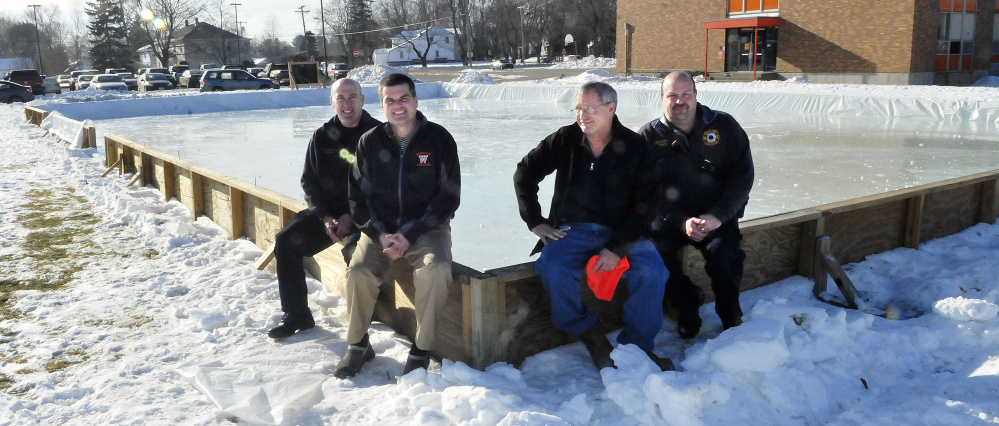 The expanded outdoor public ice skating rink beside the Winslow Middle School opens Saturday. From left are Winslow firefighter Tom Brown, Jim Bourgoin, director of Winslow Parks and Recreation, Ray Caron and firefighter Eric Rood.