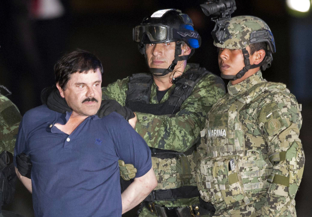 Joaquin “El Chapo” Guzman is made to face the press as he is escorted to a helicopter in handcuffs by Mexican soldiers and marines at a federal hangar in Mexico City, Mexico.
