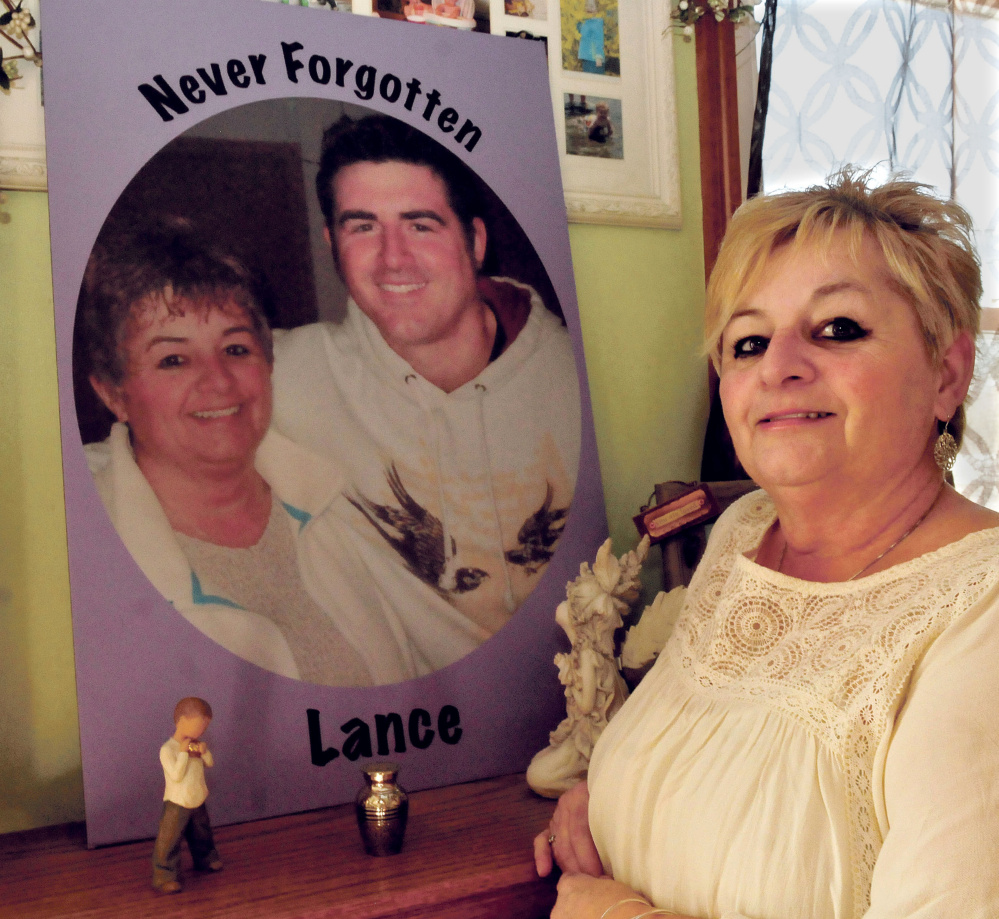Ruth Perkins on Thursday stands beside a painting of herself and her son, Lance. Before he died of an overdose in April 2015, Perkins didn’t know her son was using heroin.