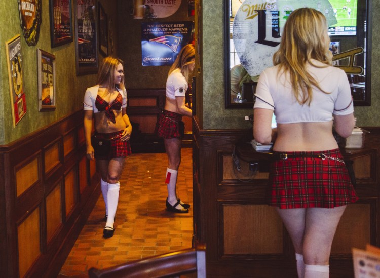 Tilted Kilt server/entertainers enter drink orders and wait tables Friday in South Portland. The restaurant officially opens Monday in the former Newick’s Lobster House building near the Maine Mall.