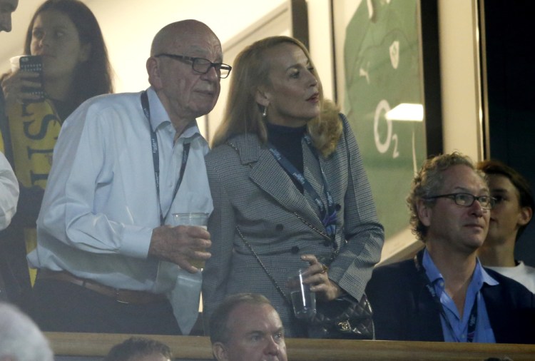 Media mogul Rupert Murdoch stands with model Jerry Hall during the Rugby World Cup final between New Zealand and Australia at Twickenham Stadium, London.