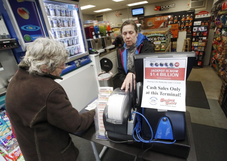Owner Rose West sells Powerball tickets to Jan Corey of South Portland at Broadway Variety in South Portland on Tuesday. The store received a secondary terminal which will come in handy if business gets as busy as it did last weekend, when the line stretched out the door with customers waiting to purchase tickets.