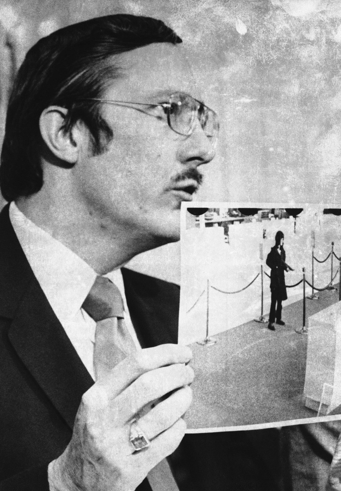 U.S. Attorney James L. Browning Jr. holds a bank surveillance photo during the 1976 trial of Patty Hearst on bank robbery and other charges.