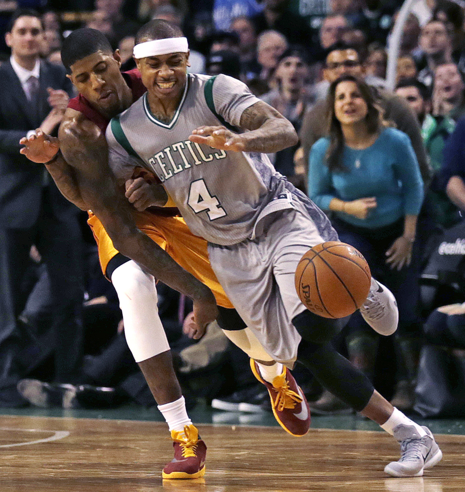 Celtics guard Isaiah Thomas steals the ball from Pacers forward Paul George in the second half. Thomas led the Celtics with 28 points. The Pacers wore old-fashioned Hickory High School uniforms from the movie “Hoosiers.”