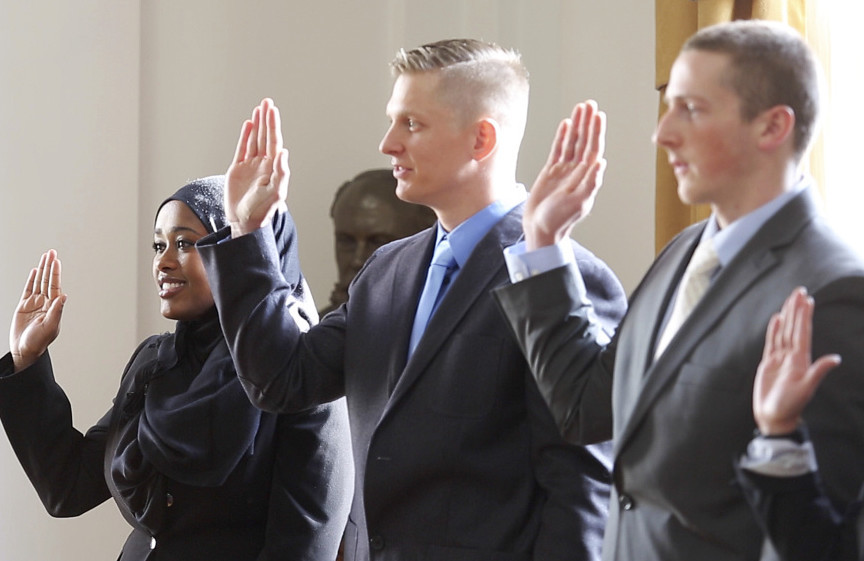 Zahra Abu, left, is sworn in as a Portland police officer on Jan. 8, along with Darrel Gibson, David Moore and Concetta Puleo. Only 3 percent of those who apply are hired, according to Chief Michael Sauschuck; the application process is rigorous and entails a series of physical and psychological exams.