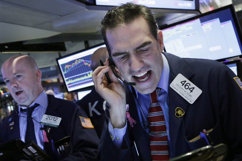 Stock trader Gregory Rowe works at the New York Stock Exchange on Friday.