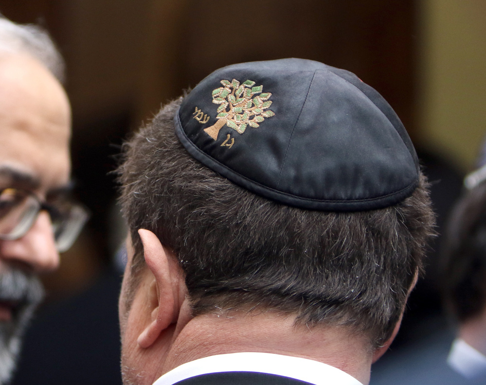 A member of the Jewish authority waits outside during a visit from Interior Minister Bernard Cazeneuve at the synagogue in Marseille on Thursday.