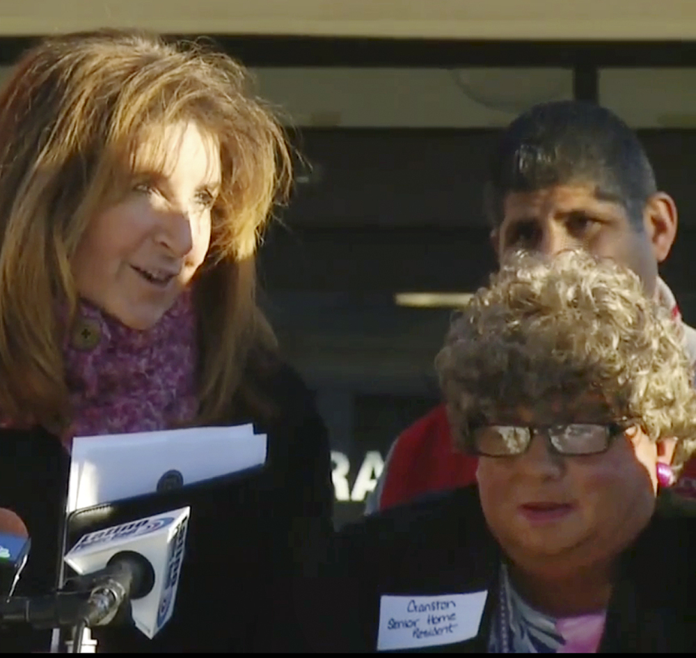 In this Jan. 5 still image from video, Sue Stenhouse, left, speaks alongside a man dressed as a woman during a news conference in Cranston, R.I.