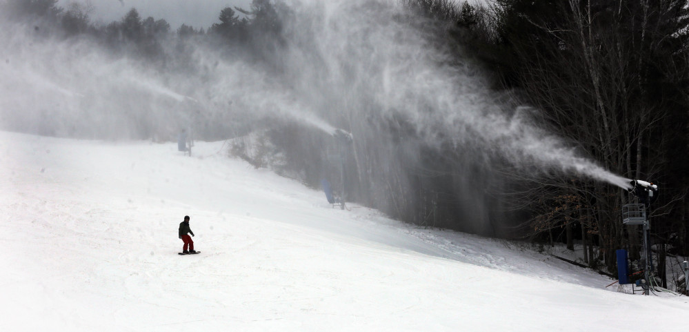A snowboarder makes his way down the mountain Friday at Attitash ski area in Bartlett, N.H. New England ski resorts are hoping the fresh snow this weekend will help make up for poor business during the warm Christmas season.