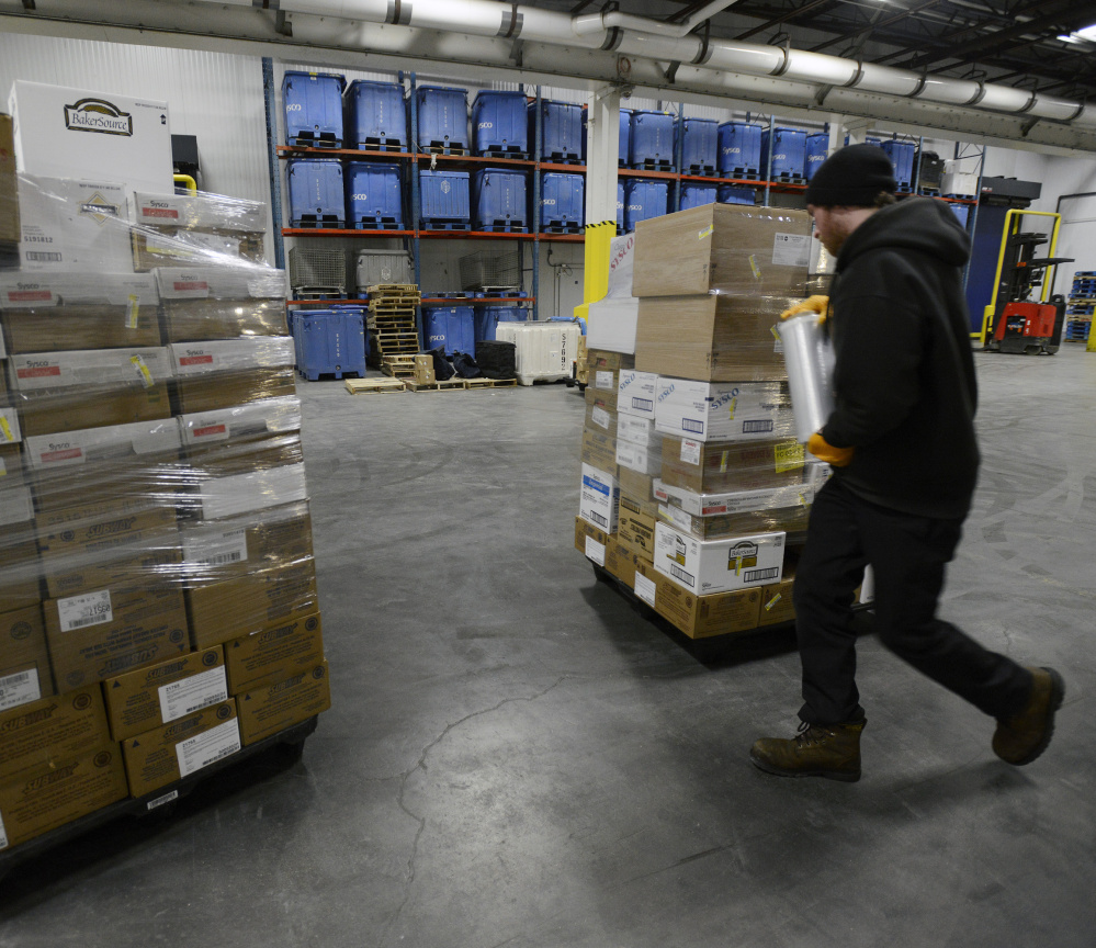 A worker wraps a pallet of food in plastic as he prepares to load a truck at Sysco food services in Westbrook. A federal study shows Mainers spend $3,736 a year on food, way above the U.S. average of $2,780.