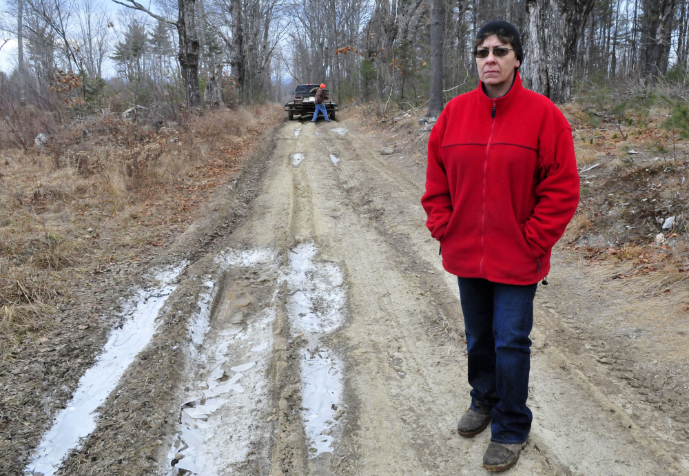Fayelyne Genness stands in the middle of the unmaintained Brown Road extension that leads to her home in Mercer. Behind her is property owner and First Selectman Vern Worthen, who Genness says is trying to block her access.
Morning Sentinel photos