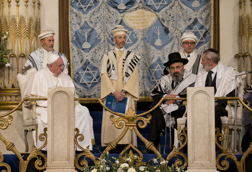 Pope Francis sits with Rabbi Riccardo Di Segni, right, during his visit to the Great Synagogue of Rome on Sunday.