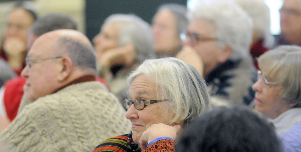 Guests listen Monday to panelists during a Martin Luther King Day forum at St. Francis Xavier Roman Catholic Church in Winthrop.