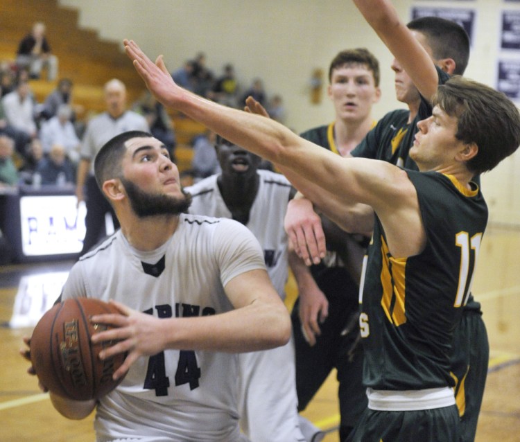 Raffaele Salamone of Deering looks for room to get off a shot while defended by Cole Verrier of Oxford Hills during a Class AA North basketball game Monday in Portland. Deering improved to 11-1 with an 81-59 win.