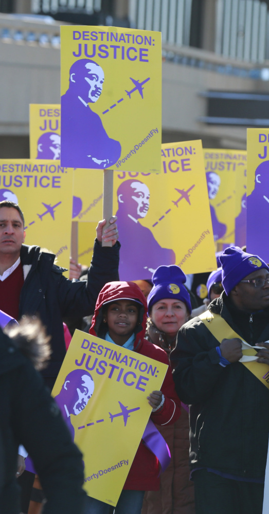 Union members in Newark, N.J., march at Newark Liberty International Airport on Monday to bring attention to their request for a $15-an-hour minimum wage.