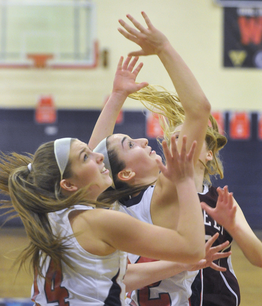 Gray-New Gloucester’s Emily Thibeault, left, and Brianna Jordan battle for a rebound against Greely on Monday afternoon. Both teams are 10-3.
