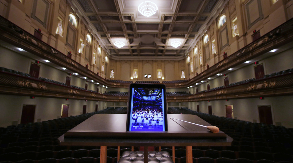 An iPad with a Boston Symphony Orchestra interactive program is displayed on the conductor’s stand at Symphony Hall in Boston. 