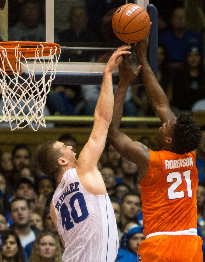 Duke’s Marshall Plumlee, left, blocks a shot by Syracuse’s Tyler Roberson during a 64-62 win by Syracuse at Cameron Indoor Stadium in Durham, North Carolina, on Monday.