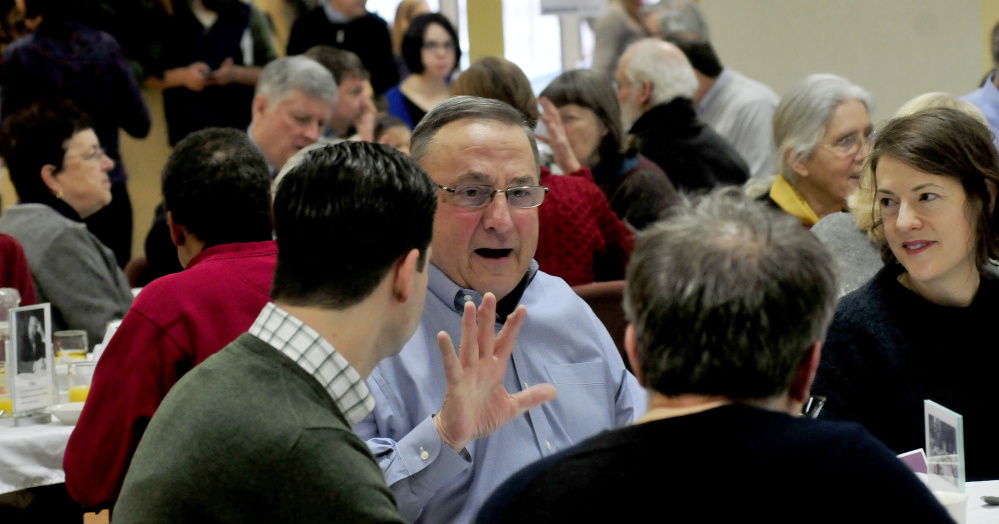 Gov. Paul LePage speaks with Waterville Mayor Nick Isgro and Sharon Corwin on Monday during the 30th annual Martin Luther King Jr. breakfast event at the Muskie Center in Waterville.