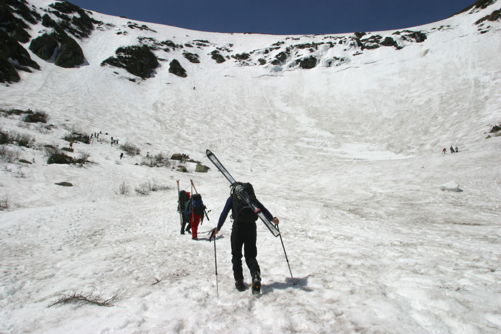 Skiers enter the bowl of Tuckerman Ravine in 2003. Kaj Huld was ascending a slope in the ravine below two climbers in The Chute, which runs between the two rock outcroppings at upper left, when unstable snow let loose and swept them away.