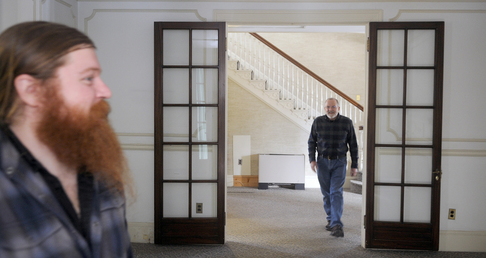 AUGUSTA, ME - JANUARY 19: Tyler Quist, left, and his father, David, explore Tuesday January 19, 2016 the Gannett House in Augusta during an announcement by the heirs of publisher Guy Gannett that the former state office building will be converted into a First Amendment museum. Tyler Quist, of Freeport, is Gannett's great grandson.(Staff photo by Andy Molloy/Staff  Photographer)