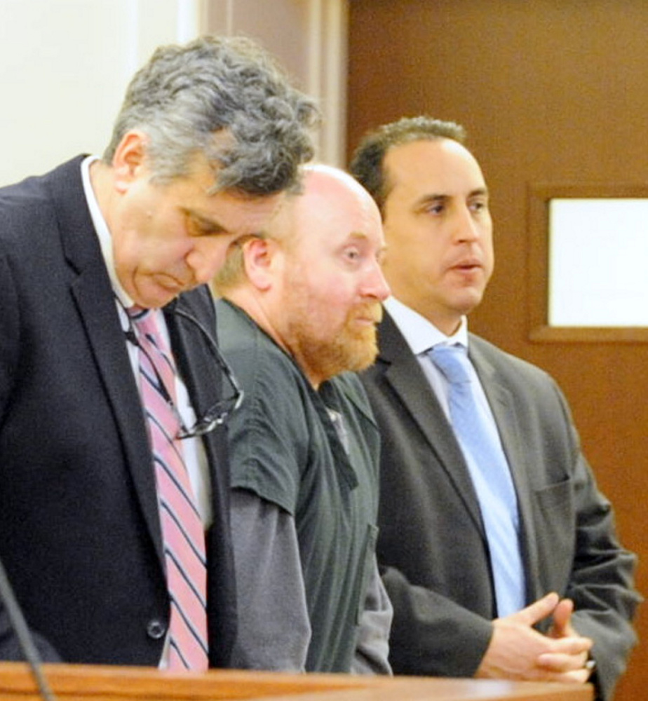 Attorneys Ronald Bourget, left, and Darrick Banda, right, stand with Roland Cummings on Thursday during Cummings’ sentencing at the Capital Area Judicial Center in Augusta. Cummings was sentenced to life in prison.