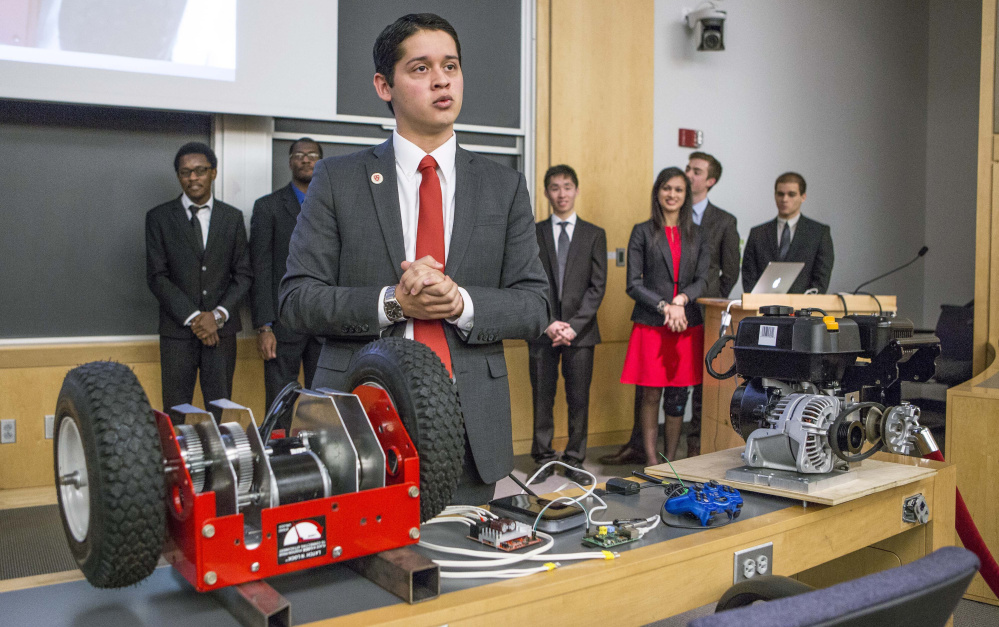 Harvard junior Cesar Maeda explains a robotic remote-control rooftop snowblower. Eighteen juniors also invented a super-heated icicle cutter and a freeze-resistant doormat.