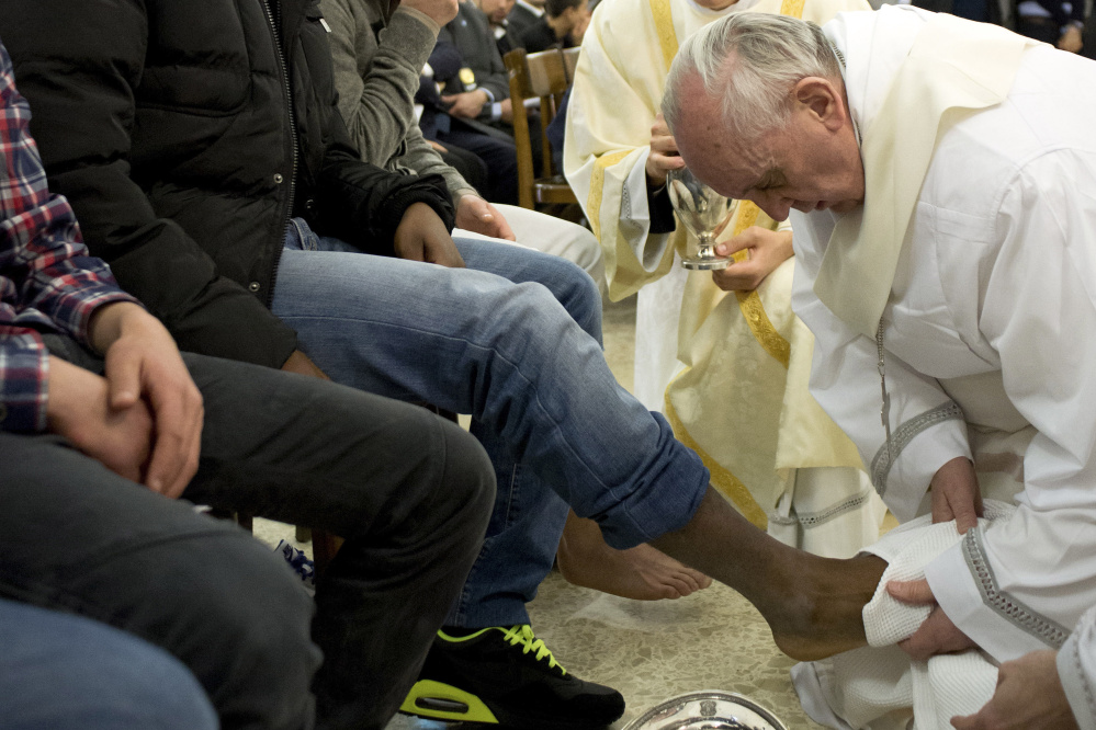 Pope Francis washes feet during a Holy Thursday rite that had long called for only men to participate. The pontiff washed the feet of two women, raising concern among traditionalists.