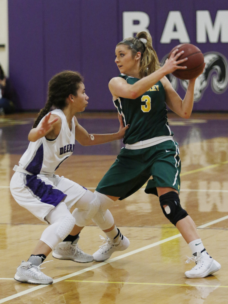 McAuley’s Sarah Clement, right, looks for an open teammate while being guarded by Deering’s Abby Ramirez, left, during the first half Friday in Portland.
Joel Page/Staff Photgrapher
