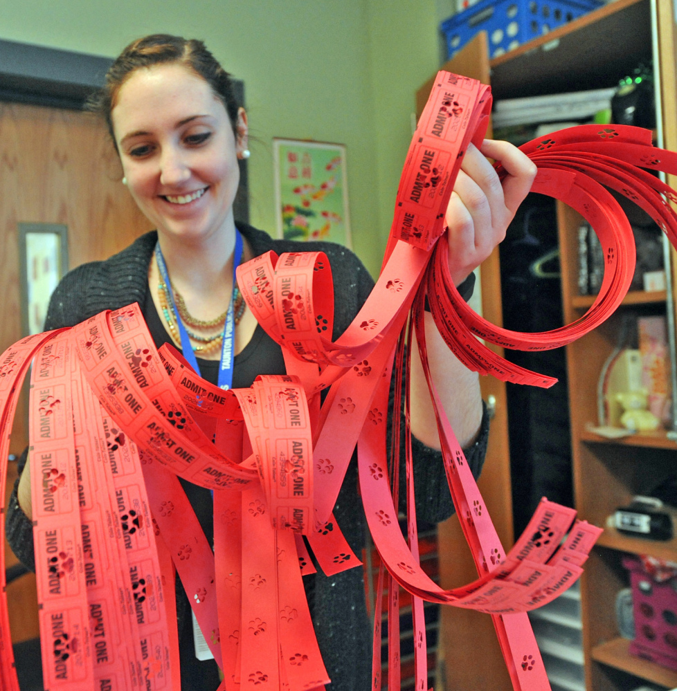 Parker Middle School teacher Nora Sweeney holds red tickets used in the school’s new Positive Behavioral Interventions and Supports program in Taunton, Mass.