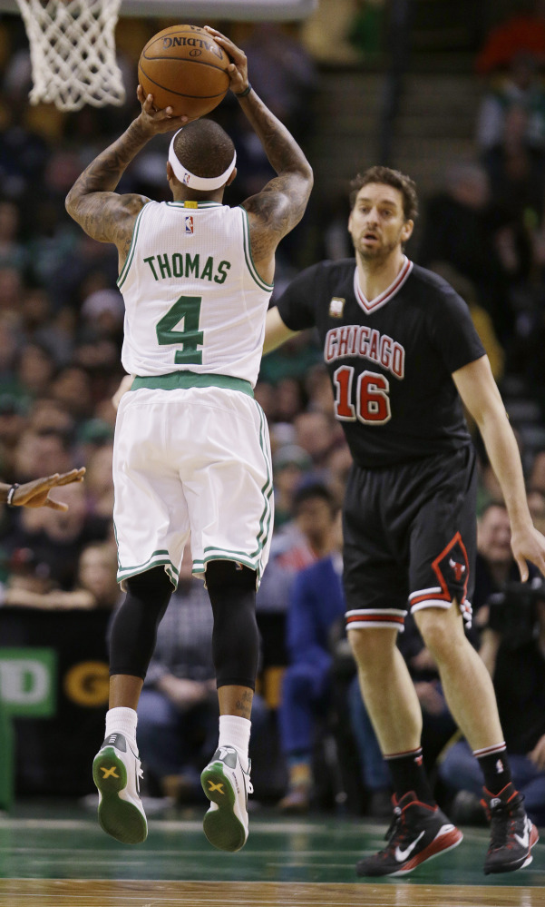 Celtics guard Isaiah Thomas shoots a jumper as Chicago center Pau Gasol watches in the first quarter.