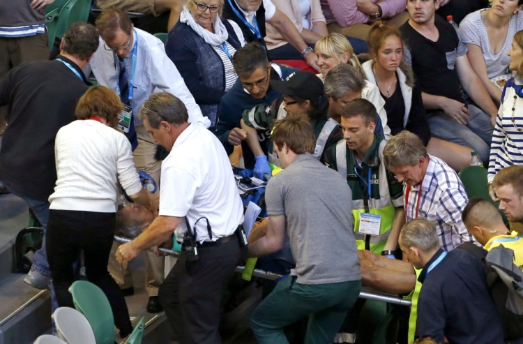 Nigel Sears, coach of Serbia’s Ana Ivanovic, is carried on a stretcher from Rod Laver Arena following a medical emergency during Ivanovic’s third round match against Madison Keys of the United States at the Australian Open in Melbourne, on Saturday.