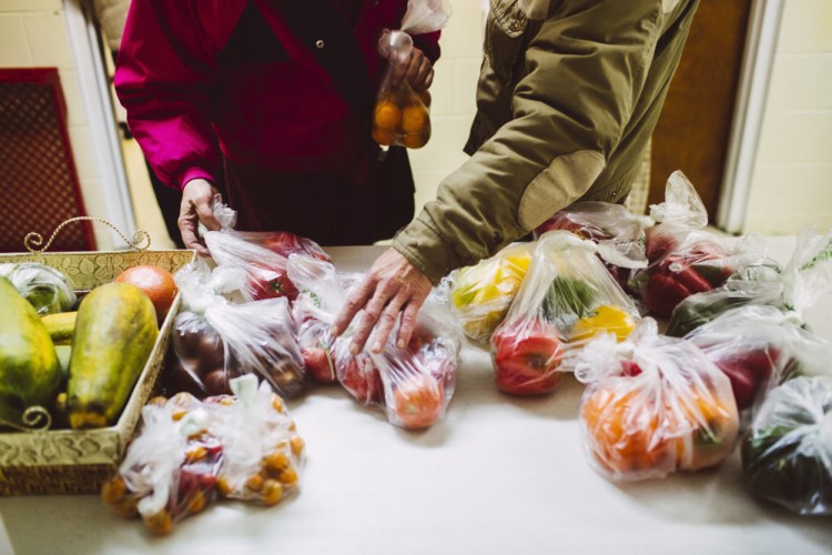 Although they both have full-time jobs, Elizabeth and Kevin Leonard struggle to make ends meet and are among the growing number of area residents who depend on the charity meals provided by the Stroudwater Christian Church.