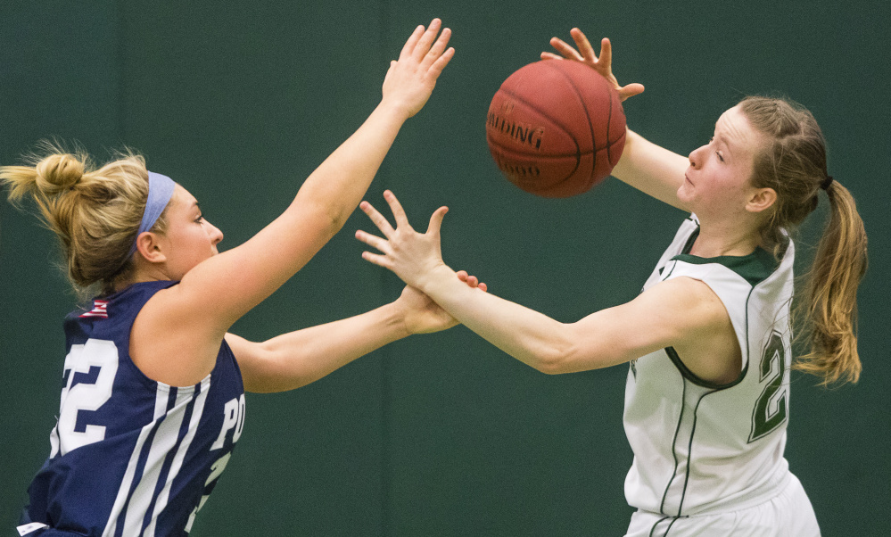 Poland guard Sarah Bolduc, left, battles for a loose ball with Waynflete’s Arianna Giguere during their Western Maine Conference basketball game Saturday in Portland. Poland won, 52-40.