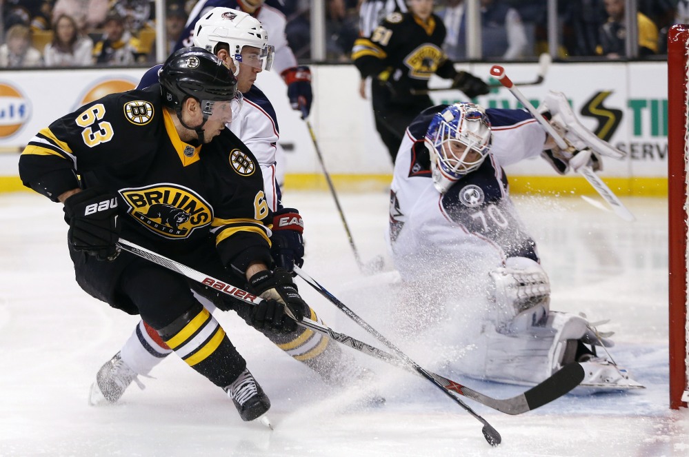 Brad Marchand of the Bruins sends a backhander past Columbus goaltender Joonas Korpisalo for a second-period goal Saturday night. Boston won in a shootout.