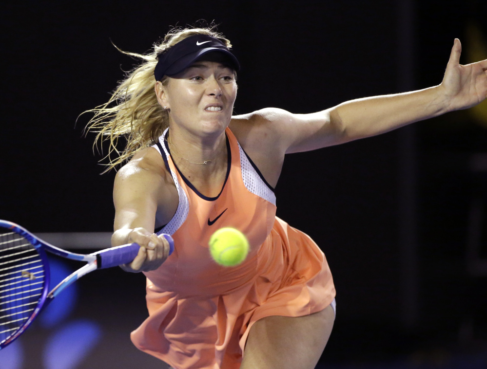 Maria Sharapova hits a forehand return to Belinda Bencic during their fourth-round match Sunday at the Australian Open. Sharapova won in straight sets, 7-5, 7-5.