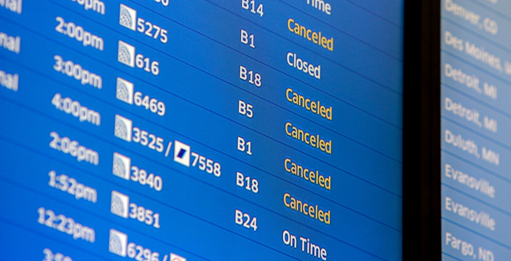 Flight boards at O’Hare International Airport show cancellations Friday in Chicago.