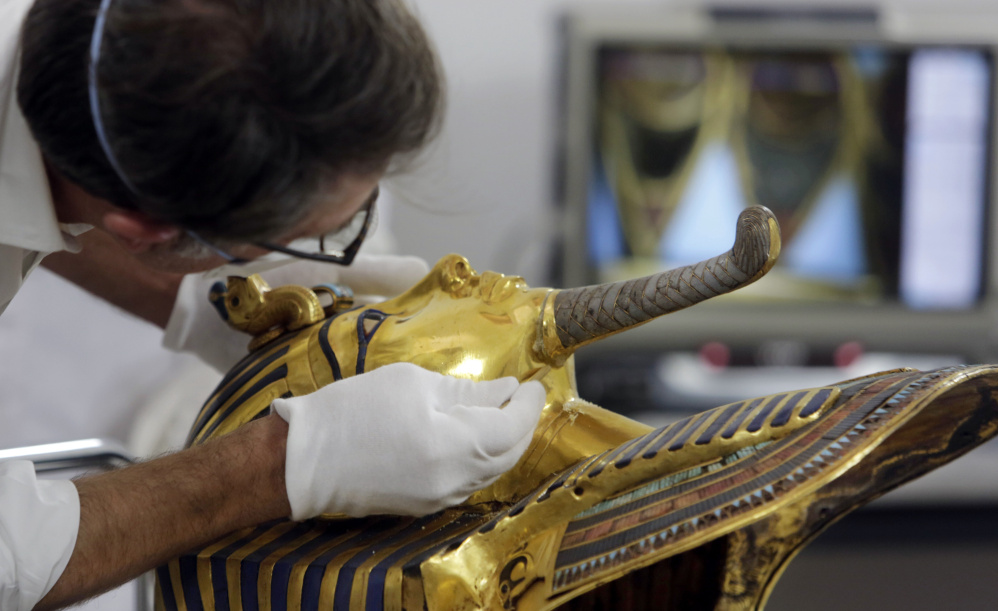German restorer Christian Eckmann begins restoration work on the golden mask of King Tutankhamun in October, over a year after the beard was accidentally broken off and hastily glued back with epoxy, at the Egyptian Museum in Cairo.