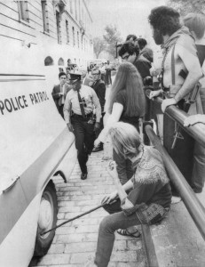 Brad Fox, 20, tries to deflate a tire on a police van outside the Cannon House Office Building in Washington, D.C., on Oct. 6, 1968. Inside the van were anti-war activists Abbie Hoffman and his wife, Anita, who had been arrested because Hoffman was wearing a shirt that looked like the U.S. flag. Hoffman, who was the leader of the anti-establishment Youth International Party or Yippies, was there to testify before the House Un-American Activities Committee about clashes that had occurred between police and protesters at the 1968 Democratic National Convention in Chicago. Fox, who was a Yippie organizer, also was arrested and jailed overnight. To his right is Jerry Rubin, another Yippie leader, with no shirt or shoes and a toy AK-47 slung from his shoulder.
