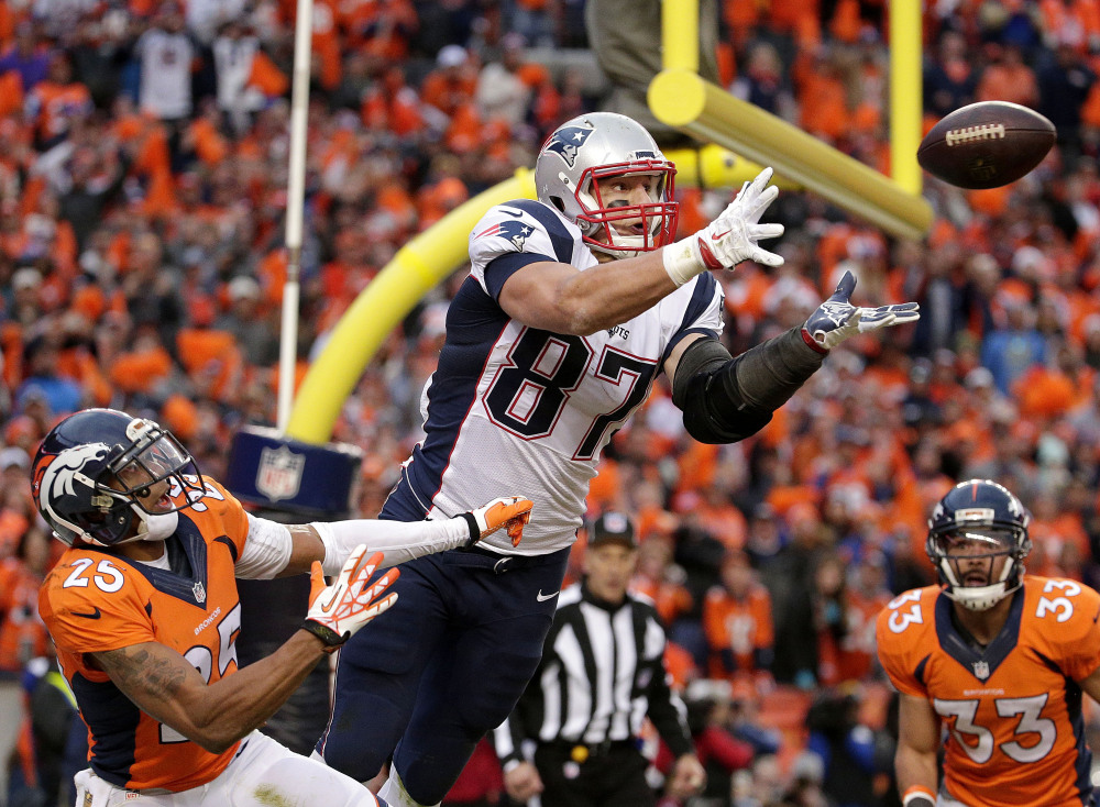 Patriots tight end Rob Gronkowski leaps in front of Broncos cornerback Chris Harris to catch a 4-yard touchdown pass late in the AFC championship game Sunday. The touchdown pulled New England within 20-18, but the Patriots missed the 2-point conversion.