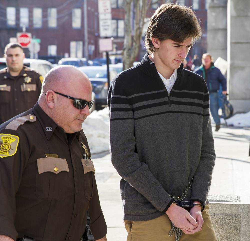 Mathew Gwyer is led into the Cumberland County Courthouse on Monday for a hearing in connection with the shooting of Scarborough man. Scarborough's police chief said residents are struggling to comprehend how such a crime could have happened, and that has led some to speculate and place blame.