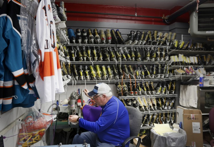 Bob Schank repairs elbow pads at Hockey Bob's Pro Shop at the Biddeford Ice Arena .
Derek Davis/Staff Photographer