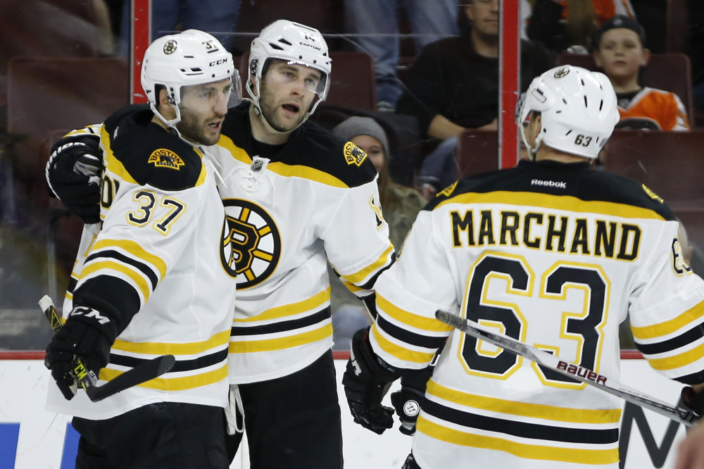 Bruins, from left, Patrice Bergeron, Brett Connolly and Brad Marchand celebrate Connolly’s game-winning goal.