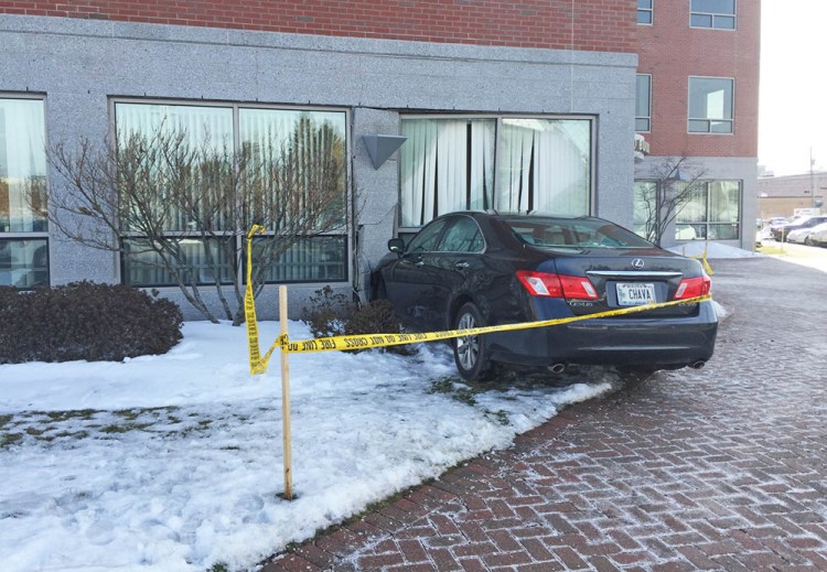 Part of the AAA of Northern New England building on Marginal Way was evacuated Tuesday morning until a structural engineer could determine whether it was safe to remove the car that crashed into the structure.