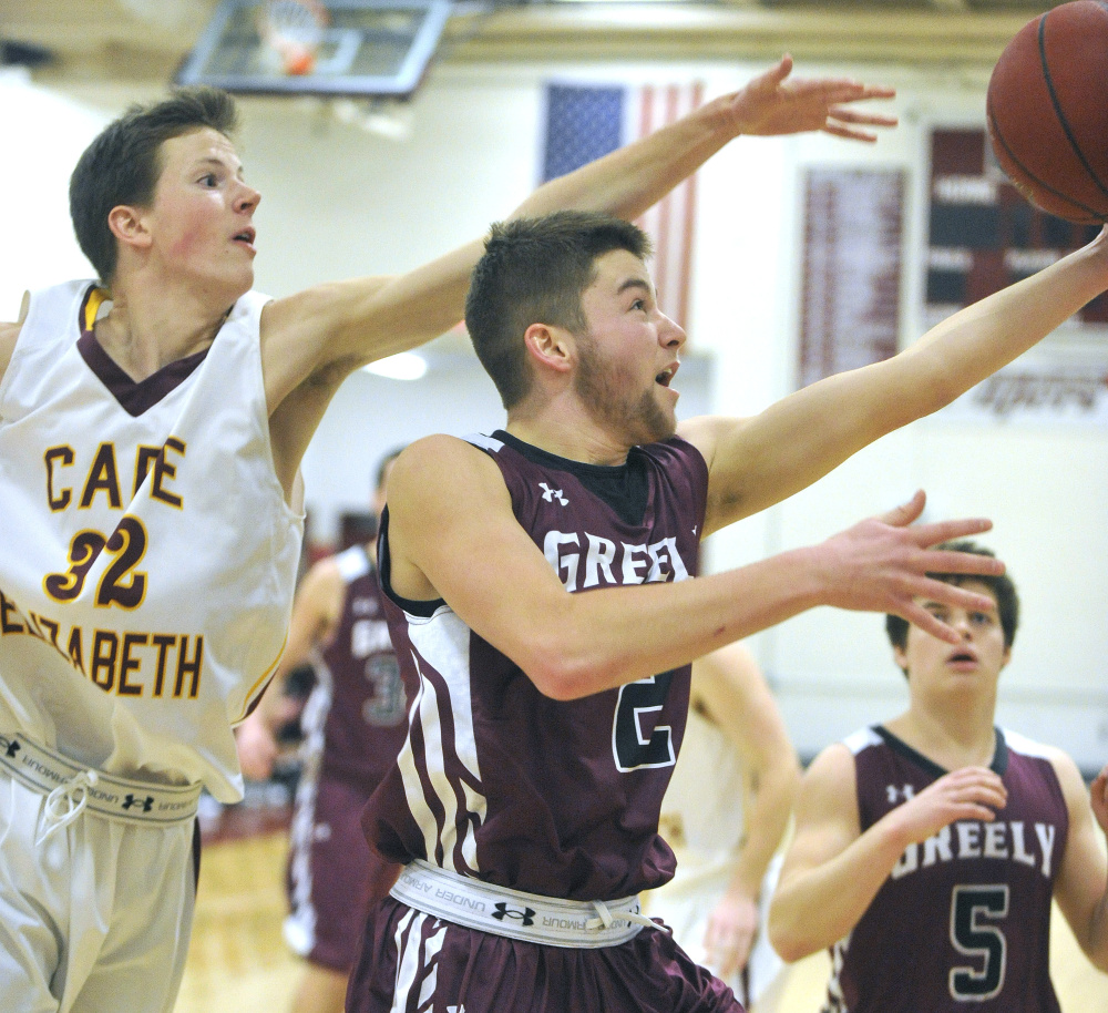 John Ewing/Staff Photographer
Greely’s Caleb Normandeau, right, takes a shot while being defended by Cape Elizabeth’s James Bottomley on Monday in Cape Elizabeth.