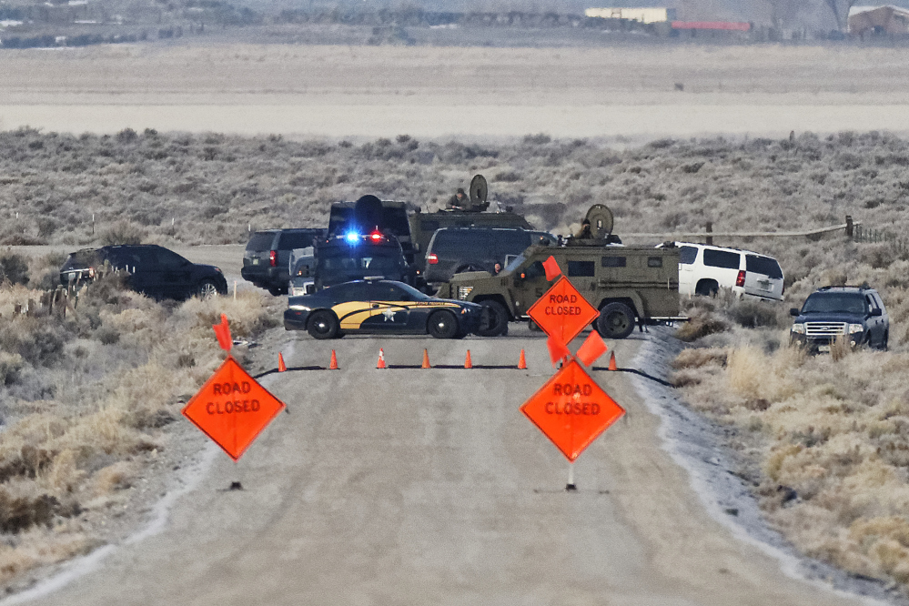 Law enforcement personnel block an access road to the Malheur National Wildlife Refuge on Wednesday near Burns, Ore. The refuge is occupied by an armed group.