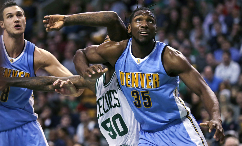 Nuggets forward Kenneth Faried blocks out Boston’s Amir Johnson on a rebound in the second quarter Wednesday night in Boston.