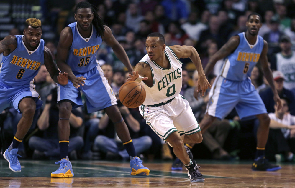 Celtics guard Avery Bradley looks to pass as he threads through Denver’s defense in the second half Wednesday at Boston. Bradley scored 27 points in Boston’s 111-103 win.