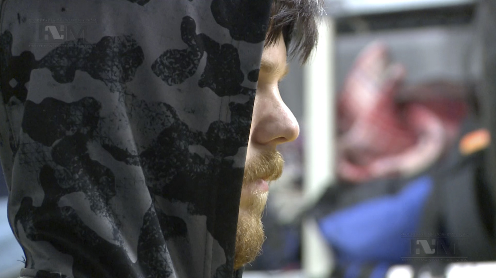 A hooded Ethan Couch, is processed by Mexican immigration agents, in Mexico City. before being escorted onto a commercial plane, en route to Dallas.